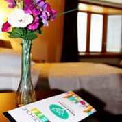 bedside table with flowers and brochure