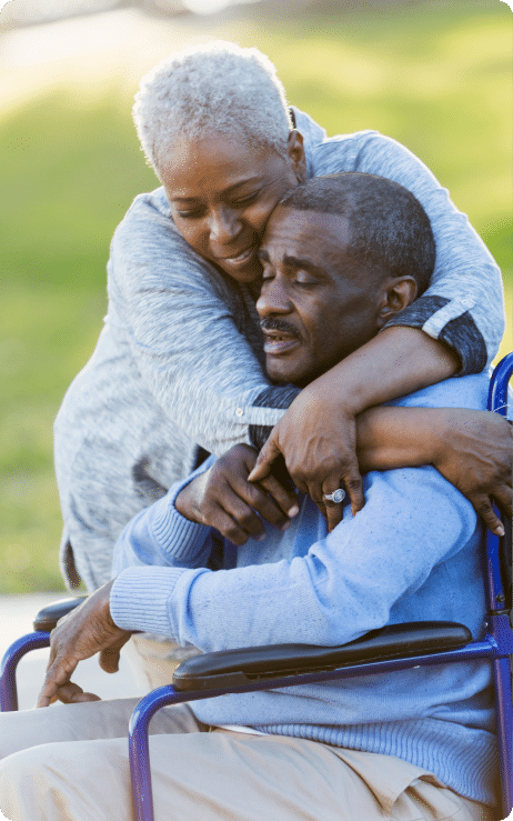 woman hugging a man in a wheelchair