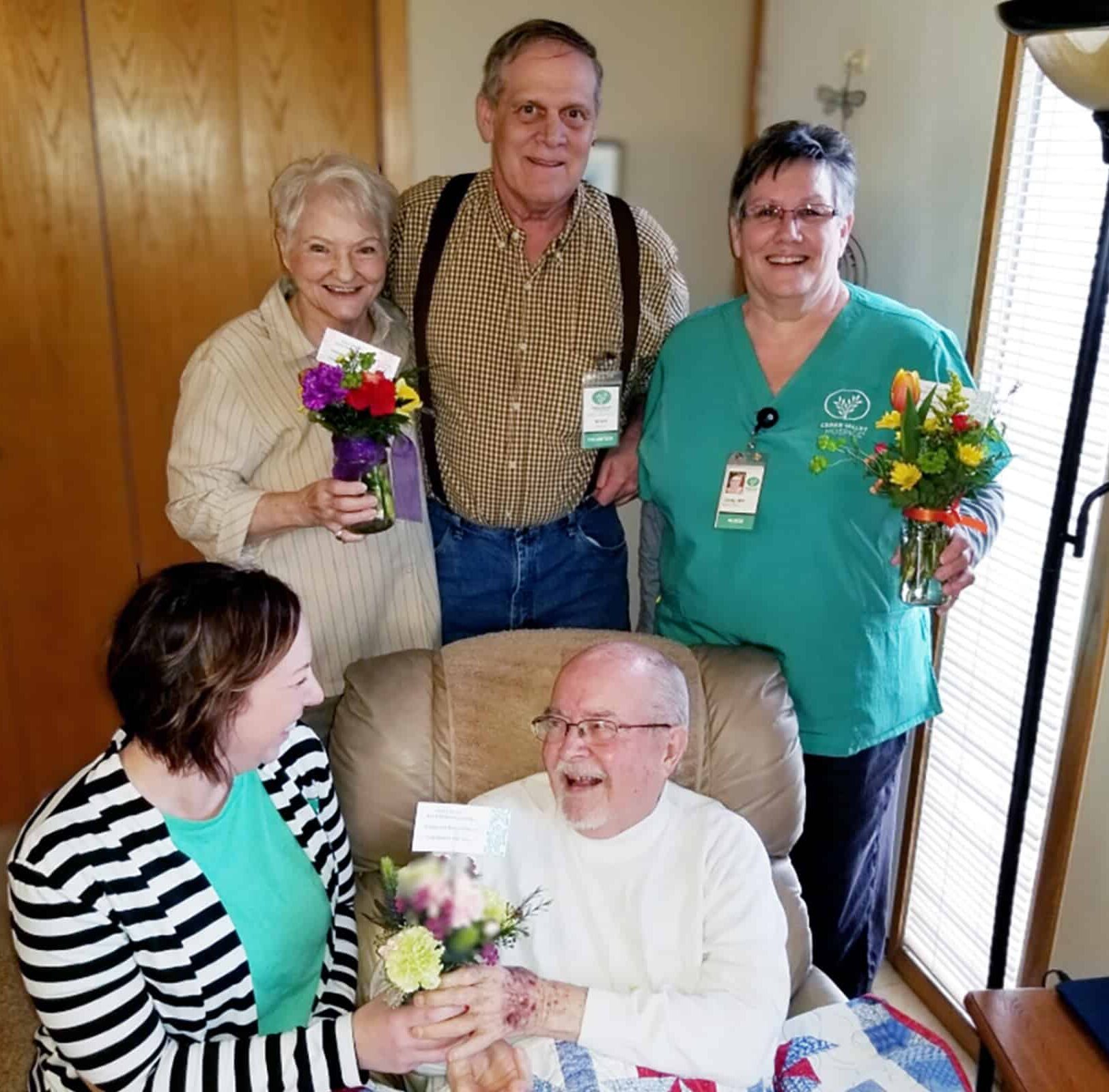 Caregiver smiling with patient and patient's family