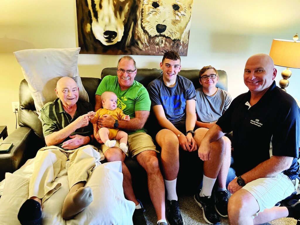 Larry Shollenbarger poses for a picture with his sons, grandson and great-grandson while on our hospice program.